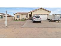 Single-story home with a two-car garage and landscaped front yard at 5830 E Fox Hollow Ln, San Tan Valley, AZ 85140