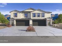 Two-story home with attached garage and desert landscaping at 9831 S 11Th St, Phoenix, AZ 85042