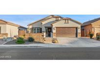 Single story home with a two-car garage and well maintained landscaping at 10808 W Cottontail Ln, Peoria, AZ 85383