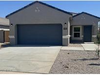 Charming single-story home with neutral gray exterior, a two-car garage, and well-maintained landscaping at 1413 W Hess Ave, Coolidge, AZ 85128