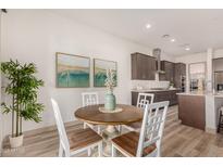Charming kitchen dining area with wood table and white chairs at 16884 W Pinchot Ave, Goodyear, AZ 85395