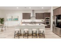 Modern kitchen with island, stainless steel appliances, and ample counter space at 16884 W Pinchot Ave, Goodyear, AZ 85395