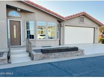 Charming single-story home featuring a two-car garage and a red tile roof at 3301 S Goldfield Rd # 3038, Apache Junction, AZ 85119