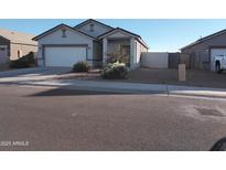 Single-story house with a two-car garage and desert landscaping at 36061 W Santa Clara Ave, Maricopa, AZ 85138