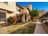 Inviting exterior of a two-story townhome with landscaping and parking at 921 W University Dr # 1136, Mesa, AZ 85201