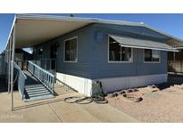 Mobile home with carport, ramp, and landscaped yard at 9501 E Broadway Rd # 107, Mesa, AZ 85208
