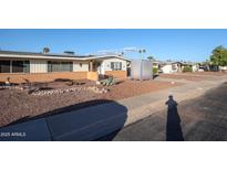 Ranch-style home with brick facade and landscaped front yard at 10620 W Clair Dr, Sun City, AZ 85351