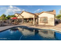 Inviting backyard oasis with sparkling pool, patio, and lush landscaping at 11122 N 165Th Ave, Surprise, AZ 85388