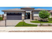 Single-story home with a two-car garage and landscaped front yard at 1176 E Ridgerock St, Casa Grande, AZ 85122