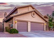 Two-car garage with beautiful desert landscaping and unique circular window design at 15237 S 19Th Way, Phoenix, AZ 85048