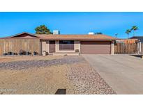 Single story home with a two car garage and well-manicured yard at 1604 W Kerry Ln, Phoenix, AZ 85027