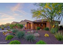 Stunning desert landscape surrounds this single-story home with a welcoming front porch at 17716 E Silver Sage Ln, Rio Verde, AZ 85263