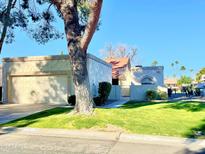 Single-story home with attached garage and well-manicured lawn at 18818 N 95Th Ave, Peoria, AZ 85382