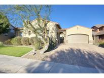 Single-story home with a large driveway and landscaped front yard at 28548 N 68Th Ave, Peoria, AZ 85383