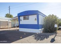 Blue and white mobile home with carport and landscaping at 345 S 58Th St # 27, Mesa, AZ 85206