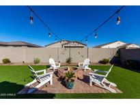 Relaxing backyard with firepit and seating area, perfect for outdoor gatherings at 35170 W La Paz St, Maricopa, AZ 85138