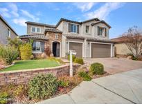 Two-story house with stone accents and a three-car garage at 44622 N Sonoran Arroyo Ln, New River, AZ 85087