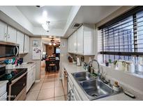 Bright kitchen with stainless steel appliances and ample counter space at 4539 W Mclellan Rd, Glendale, AZ 85301