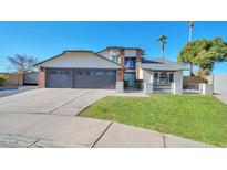 Two-story home with three-car garage and landscaped lawn at 4818 E Dartmouth Cir, Mesa, AZ 85205