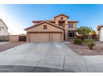 Two-story house with three-car garage and landscaped yard at 494 S 220Th Ln, Buckeye, AZ 85326