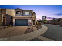 Two-story house with a dark-gray garage door and desert landscaping at 8137 N 13Th Pl, Phoenix, AZ 85020