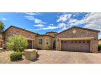 Stunning two-story home with stone exterior and a three-car garage at 12617 W Mine Trl, Peoria, AZ 85383