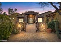 Stunning stone exterior with a gated entry and courtyard at 14705 E Redbird Rd, Scottsdale, AZ 85262