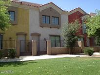 Three-story townhouses with Spanish-style architecture and grassy area at 1950 N Center St # 104, Mesa, AZ 85201