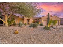 Single-story home with desert landscaping, two-car garage, and attractive facade at 19957 N Rawhide Way, Surprise, AZ 85387