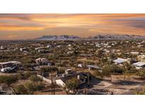 Aerial view of a house and surrounding desert landscape, mountains in the background at 2070 N Don Peralta Rd, Apache Junction, AZ 85119