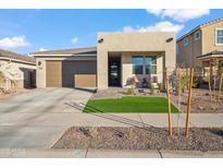 New modern home with landscaped front yard and two-car garage at 22846 E Watford Dr, Queen Creek, AZ 85142