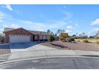 Brick house with a two-car garage and landscaped yard at 2957 E Erie Ct, Gilbert, AZ 85295