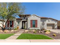 Stunning two-story home with red shutters and desert landscaping at 31023 N 117Th Dr, Peoria, AZ 85383