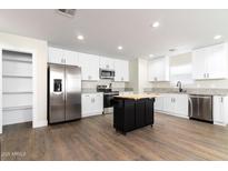 Modern kitchen with stainless steel appliances and granite countertops at 410 E Lincoln Ave, Coolidge, AZ 85128