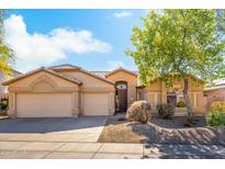 Single-story house with tan exterior, two-car garage, and landscaping at 4611 E Morning Vista Ln, Cave Creek, AZ 85331