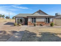 Cute single story home with brick and siding exterior, landscaping, and a paved walkway at 1055 N Recker Rd # 1215, Mesa, AZ 85205