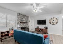 Living room features a fireplace, comfy sofa, and modern decor at 1075 E Chandler Blvd # 120, Chandler, AZ 85225