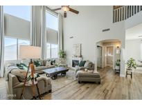 Spacious living room featuring hardwood floors, a fireplace, and ample natural light at 1253 E Debbie Dr, San Tan Valley, AZ 85140