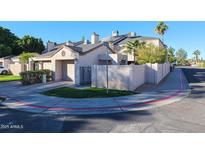 Neat stucco condo exterior with attached garage and desert landscaping at 16644 N 33Rd St # 105, Phoenix, AZ 85032