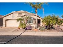 Single-story home with desert landscaping and two-car garage at 18056 W Buena Vista Dr, Surprise, AZ 85374