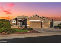 Beautiful one-story home with a two-car garage and well-manicured lawn at 18265 N 116Th Dr, Surprise, AZ 85378