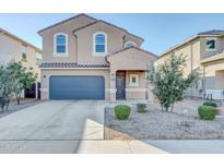 Two-story house with gray garage door and landscaping at 36085 W Prado St, Maricopa, AZ 85138