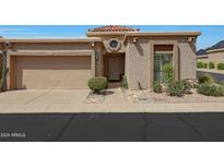 Tan stucco house with a two-car garage and nicely landscaped yard at 6318 N 19Th St, Phoenix, AZ 85016