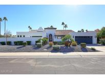 Stunning contemporary home with white stucco exterior, red tile roof, and landscaped front yard at 9789 E Cinnabar Ave, Scottsdale, AZ 85258