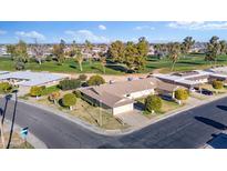 Aerial view of a ranch style home with a golf course nearby at 9802 N Balboa Dr, Sun City, AZ 85351