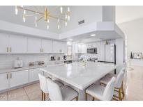Modern kitchen featuring a large island and white cabinetry at 11020 W Lane Ave, Glendale, AZ 85307