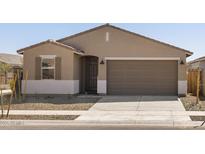 Charming single-story home featuring a two-car garage, neutral stucco, and low-maintenance landscaping at 16029 W Desert Hollow Dr, Surprise, AZ 85387