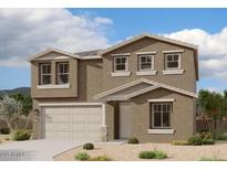 Two story house with tan exterior, three windows across the second floor and a two car garage at 32111 N Saddlehorn Dr, San Tan Valley, AZ 85140