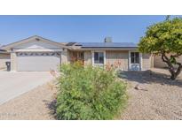 Ranch style home with solar panels and landscaped yard at 4202 W Wood Dr, Phoenix, AZ 85029