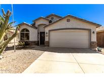 Single-story home with desert landscaping and two-car garage at 45579 W Rainbow Dr, Maricopa, AZ 85139